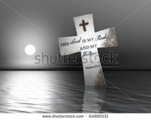 religious cross with bible verses in water at sunset