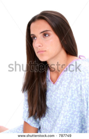 Beautiful dark haired teen girl in hospital gown crying. Eyes red with ...