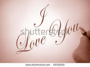 person writing I Love You in calligraphy in sepia tone - stock photo