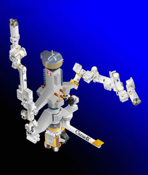 Astronaut Garrett Reisman, on the the 12-foot-tall robot Dextre, which ...