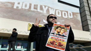 Rubin Carias holds a poster of the film 