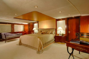 The master bedroom features a king sized bed bordered by marble topped ...