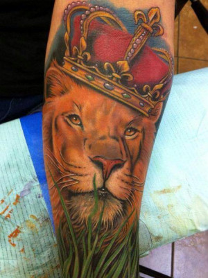 This lion tattoo adds to the royal meaning of lions by including a ...