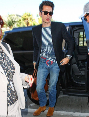 ... usual as he arrives at LAX wearing baggy jeans held up by a red tie