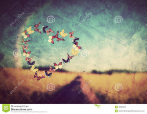 Heart shape made of colorful butterflies on vintage field background ...