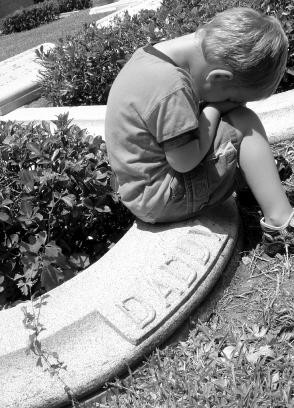 Little boy at his father's grave