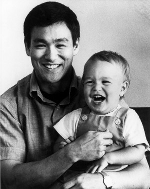 Brandon Lee and a young baby with his father, Bruce Lee.