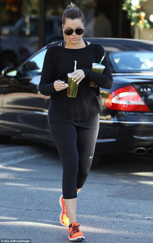 Khloe Kardashian carries two iced tea drinks from Starbucks as she ...
