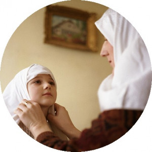 Muslim mother adjusts her daughter's hijab