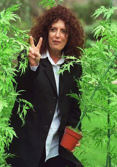 Our late founder, Dame Anita Roddick, walking through a hemp field ...