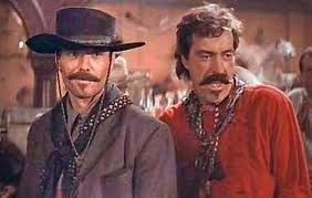 ... Biehn as Johnny Ringo and Powers Boothe as Curly Bill Brocius