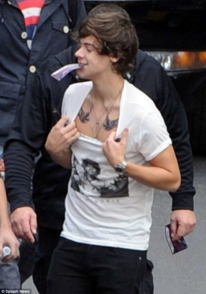 Inked: Harry proudly shows off his new body art of two birds, which ...
