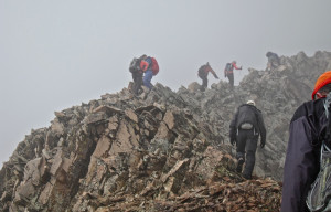 Determined climbers persist through clouds and rain on a successful ...