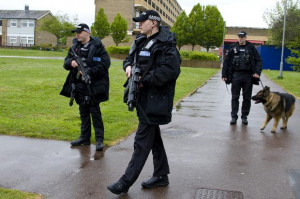 Armed police patrol the Marsh Farm estate, one of two in Luton beset ...