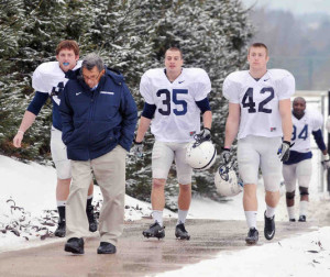 Joe Paterno leads some players to practice for their New Year's Day