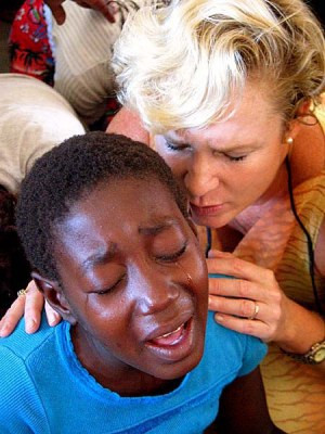 Heidi seen here praying for an African child, photographs compliments ...