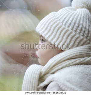 ... -white-knitted-hat-looking-outside-through-the-window-165608735.jpg