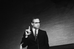 Black Nationalist ldr. Malcolm X pointing finger upward during speech ...