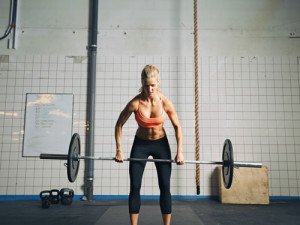 Stand in front of the barbell with knees slightly bent, while leaning ...