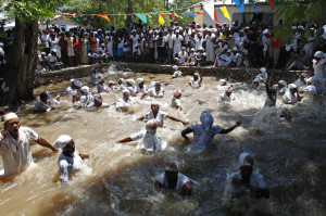 Haitians take a cleansing dip in the Ma bath on the second day of the ...