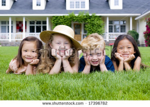 group of kids laying in the grass. Diveristy and friendship - stock ...