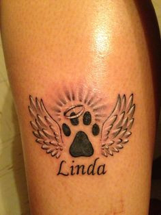 Linda Winged Paw Print Dog Tattoo On Bicep