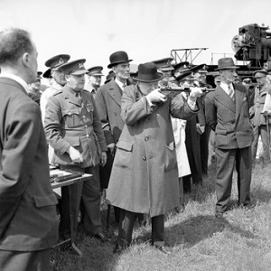 AS PRIME MINISTER 1940-45 Winston Churchill takes aim with a Sten gun ...