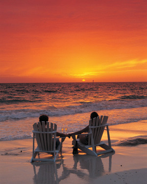 Couple-on-beach-chairs-at-sunset