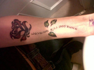 Rose Flower And Quote Tattoo On Forearm