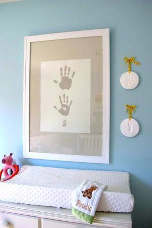 Handprints of dad, mom, and baby alongside cast hand and footprints.