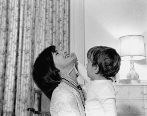 Jacqueline Kennedy laughs as John F. Kennedy Jr. plays with her ...