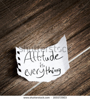 Attitude is Everything written on the paper on a wood background ...