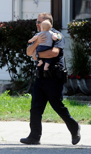 Laurel police officer carries a child to safety