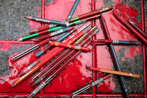 Broken pens were placed in a pool of simulated blood Friday outside ...