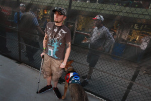 Brad Schwarz, with his service dog Panzer, attends a Cubs game with a ...