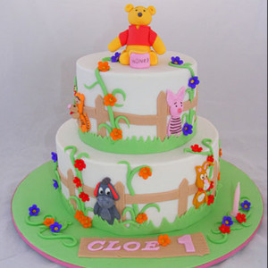 two tiered pooh bear cake two tiered round cake decorated with a ...