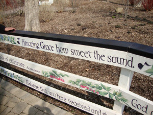 length of the fence (both sides) is painted with a variety of quotes ...