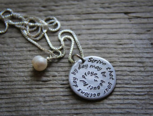 Hand-stamped metal pendant with a quote from the Bahá'í Faith ...