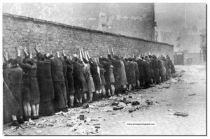 Jewish fighters lined up against the wall