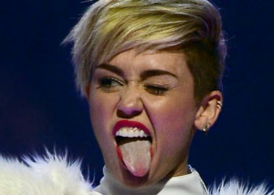 Entertainer Miley Cyrus winks and sticks out her tongue as she ...
