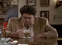 Norm Peterson ( George Wendt ) drinking beer