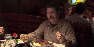 Ron Swanson with turf and turf dinner, whiskey, and a cigar.