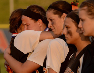 St. Charles East pitcher Haley Beno, center, is consoled by teammates ...