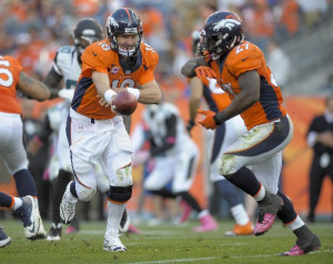 Denver Broncos quarterback Peyton Manning (18) hands the ball off to ...