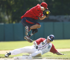 Saul Bosquez (top) leaps out of the way of an unidentified base runner ...