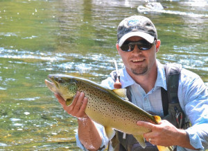 member of Fly Fishing Team USA, prepares to release a trout ...