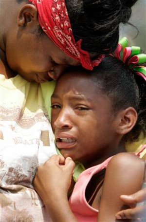 Hurricane Katrina survivors cry near the New Orleans Convention Center