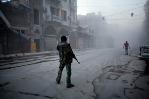 Syrian rebel stands in the street in Aleppo. Ahmed Deeb/AFP/Getty ...