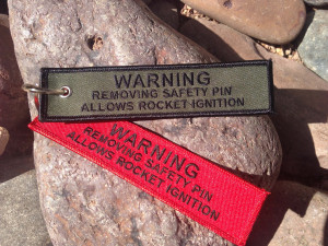 Warning Removing Safety Pin Allows Rocket Ignition” (Keychain)