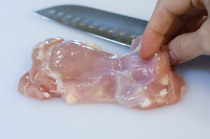Begin by cutting up the chicken thighs into small pieces.